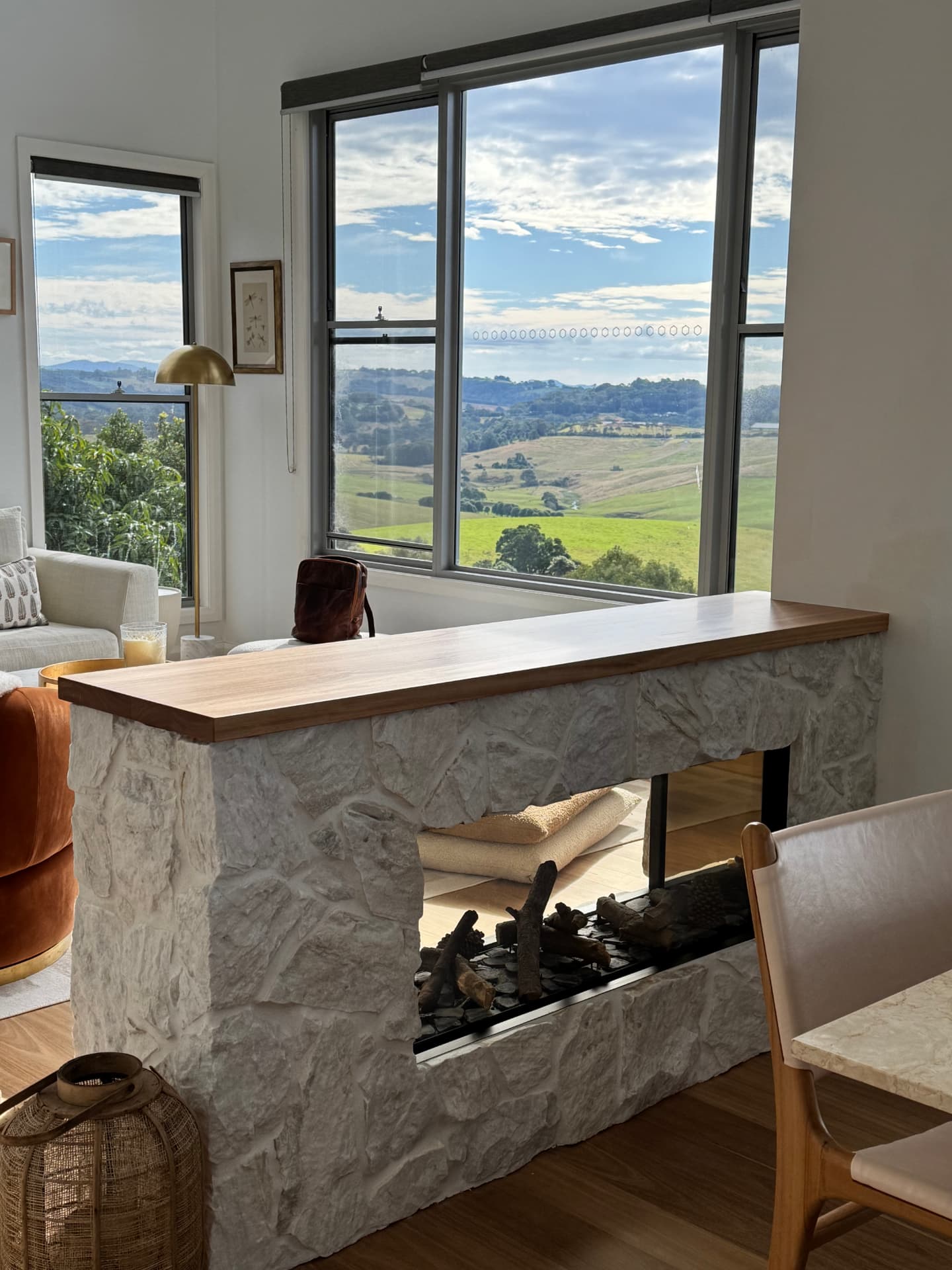 Double-sided sandstone fireplace and timber mantel at Coopers Shoot